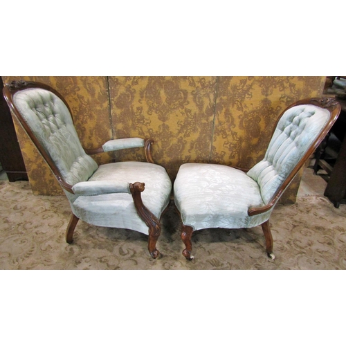 2312 - A graduated pair of Victorian walnut framed drawing room chairs with carved and moulded outline and ... 