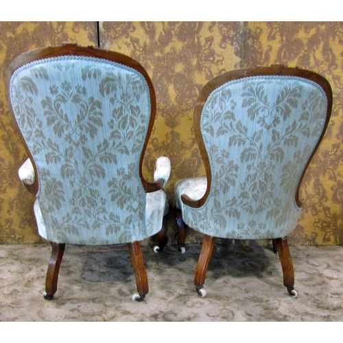 2312 - A graduated pair of Victorian walnut framed drawing room chairs with carved and moulded outline and ... 