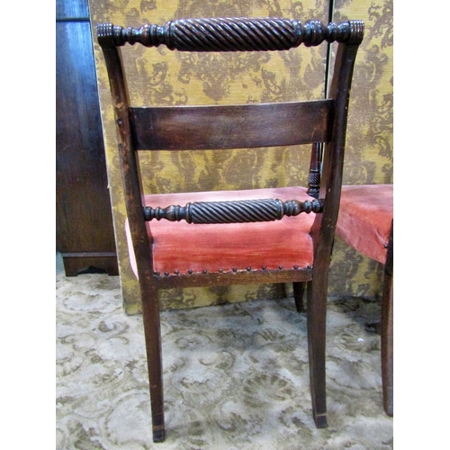 2313 - A set of four Regency mahogany dining chairs one elbow and three matching singles, all with rope twi... 