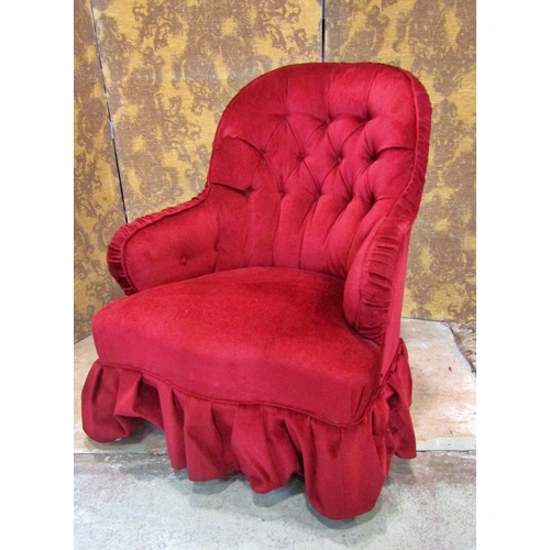 2316 - A Victorian button back drawing room chair upholstered in red velvet and raised on turned supports