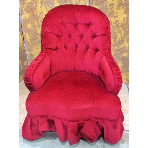 2316 - A Victorian button back drawing room chair upholstered in red velvet and raised on turned supports