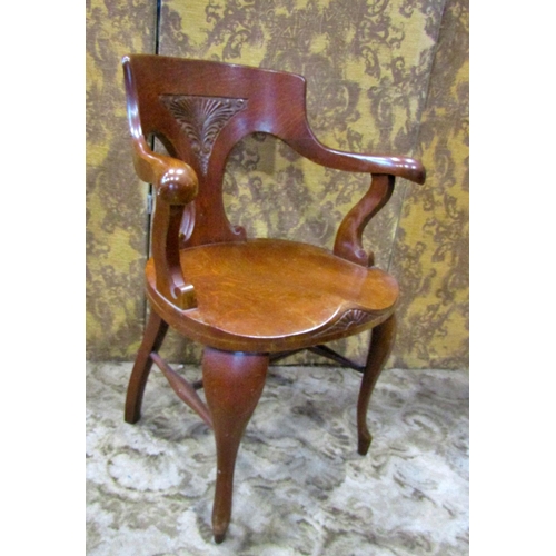 2321 - A late 19th century American oak office chair with saddle seat, carved splat back and raised on shap... 