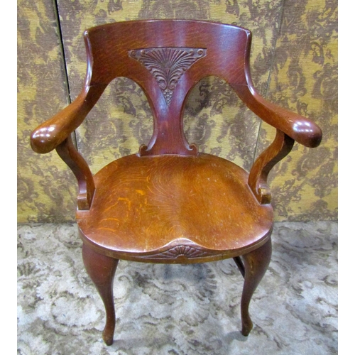 2321 - A late 19th century American oak office chair with saddle seat, carved splat back and raised on shap... 