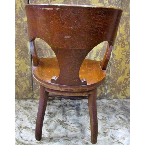 2321 - A late 19th century American oak office chair with saddle seat, carved splat back and raised on shap... 