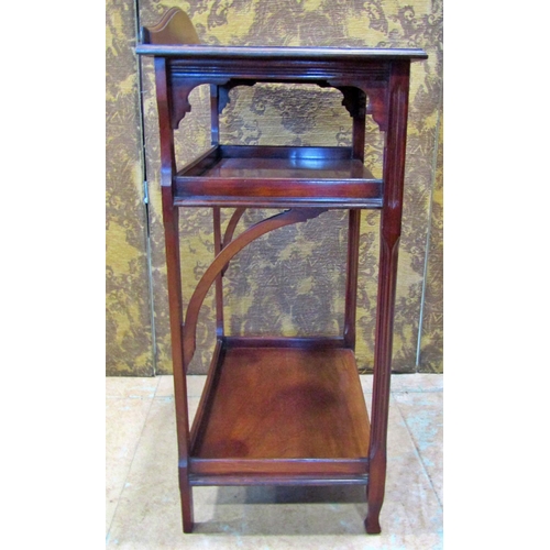 2325 - An Edwardian mahogany three tier side table with reeded column supports, 61 cm wide