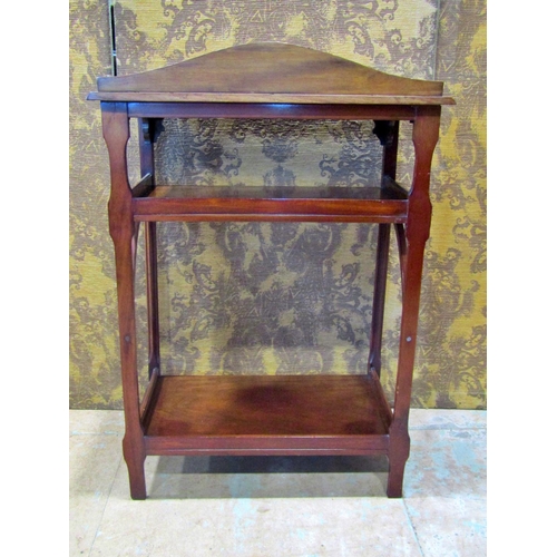 2325 - An Edwardian mahogany three tier side table with reeded column supports, 61 cm wide