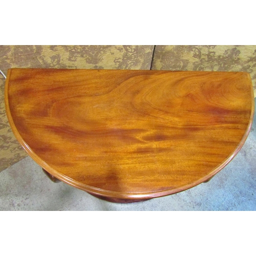 2326 - A Victorian mahogany demi-lune side table raised on lions paw supports, 120 cm wide