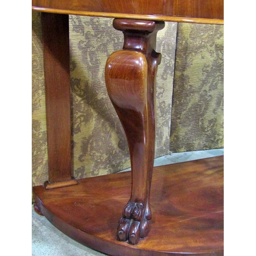 2326 - A Victorian mahogany demi-lune side table raised on lions paw supports, 120 cm wide