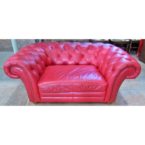 2343 - A Chesterfield double seat/small sofa with buttoned finish in a red leather colourway