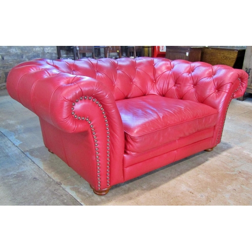 2343 - A Chesterfield double seat/small sofa with buttoned finish in a red leather colourway