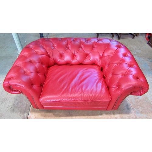 2343 - A Chesterfield double seat/small sofa with buttoned finish in a red leather colourway