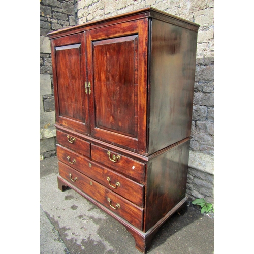 2110 - A George III mahogany gentlemen's two sectional dwarf linen press, the upper section enclosed by a p... 