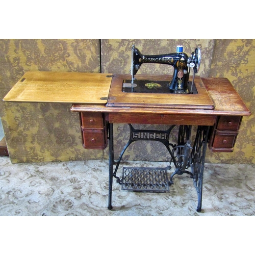 2145 - A vintage oak cased Singer treadle sewing machine