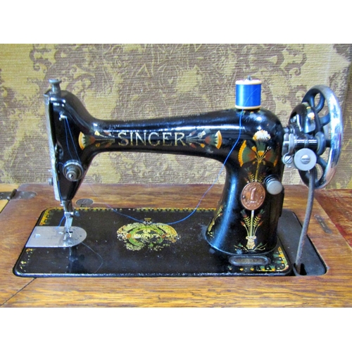 2145 - A vintage oak cased Singer treadle sewing machine