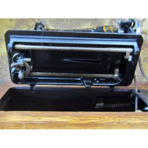 2145 - A vintage oak cased Singer treadle sewing machine