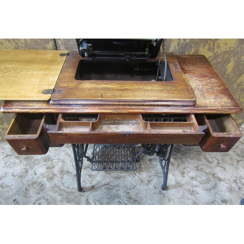 2145 - A vintage oak cased Singer treadle sewing machine