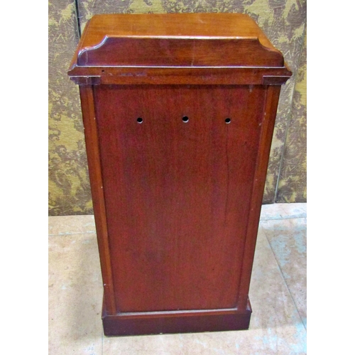 2167 - A Victorian mahogany bedside cupboard enclosed by a moulded arched panelled door