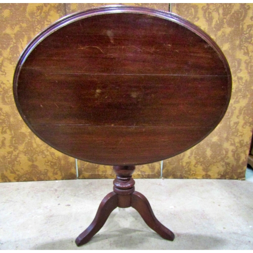 2169 - A late Victorian walnut oval tilt top table raised on a turned pillar and tripod, the top 97 cm x 70... 