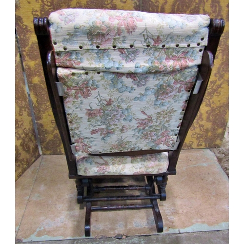 2172 - A late 19th/early 20th century walnut rocking chair with later upholstered pad seat and back within ... 