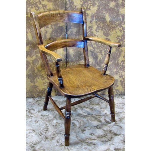 2185 - An antique stained elm and beechwood Windsor bar back elbow chair with saddle shaped seat