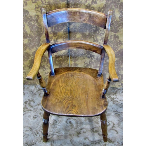 2185 - An antique stained elm and beechwood Windsor bar back elbow chair with saddle shaped seat