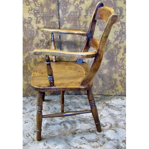 2185 - An antique stained elm and beechwood Windsor bar back elbow chair with saddle shaped seat