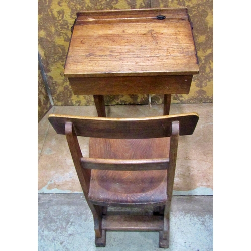 2188 - A small vintage oak child’s school desk with folding compartment and integral chair