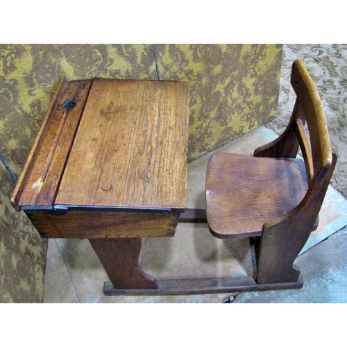 2188 - A small vintage oak child’s school desk with folding compartment and integral chair