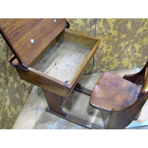 2188 - A small vintage oak child’s school desk with folding compartment and integral chair