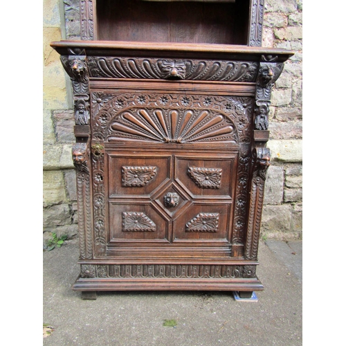 2207 - A mid 19th century continental pier cabinet the lower section enclosed by carved and panelled door w... 