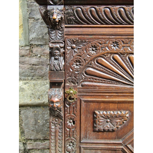 2207 - A mid 19th century continental pier cabinet the lower section enclosed by carved and panelled door w... 