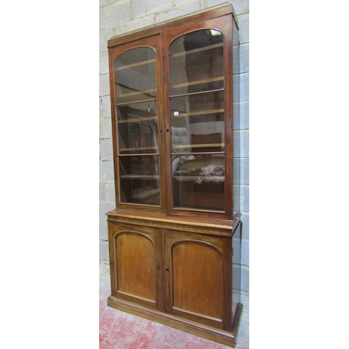 2456 - A Victorian mahogany library bookcase, the lower section enclosed by two arched and panelled doors, ... 