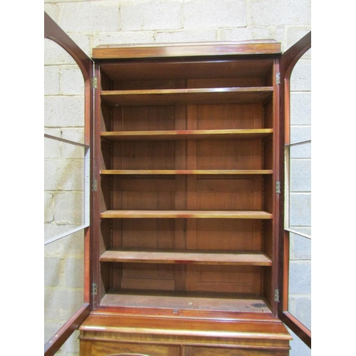 2456 - A Victorian mahogany library bookcase, the lower section enclosed by two arched and panelled doors, ... 