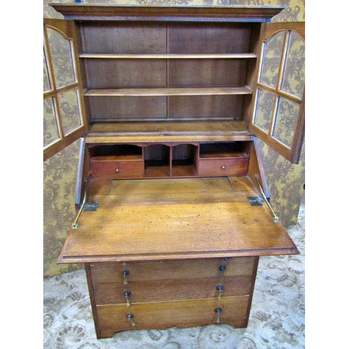 2242 - An unusual oak bureau bookcase of small dimensions, the bureau with simply fitted interior over six ... 