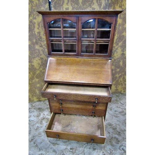 2242 - An unusual oak bureau bookcase of small dimensions, the bureau with simply fitted interior over six ... 