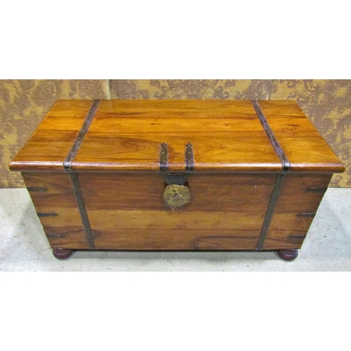 2272 - An Indian hardwood coffer with steel banded borders and brass lock plate