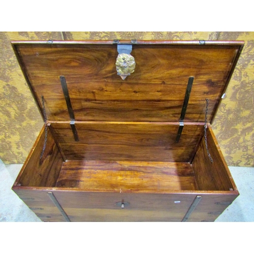 2272 - An Indian hardwood coffer with steel banded borders and brass lock plate