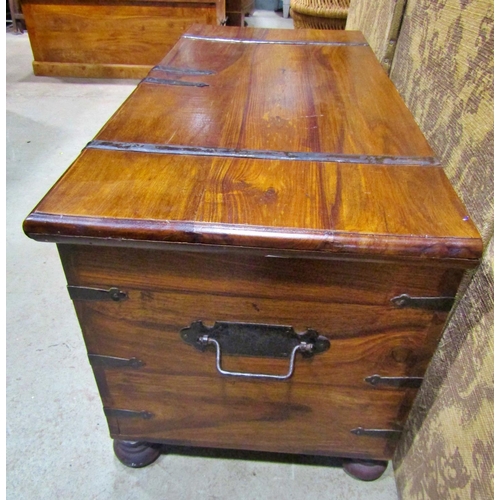 2272 - An Indian hardwood coffer with steel banded borders and brass lock plate