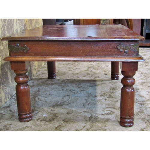 2276 - An Indian hardwood occasional table with steel bands on turned supports, 87cm max