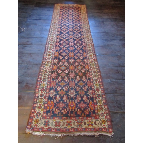 2723 - An old eastern carpet, the central field in ink blue with multi repeating abstract floral detail, wi... 