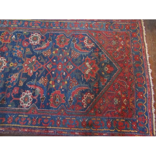 2729 - An old eastern wool runner, the central dark blue ground supporting abstract floral detail, within f... 