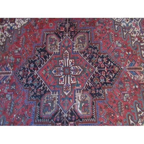 2735 - An old eastern wool carpet, the central lozenge shaped medallion upon a red field with abstract foli... 