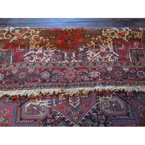 2735 - An old eastern wool carpet, the central lozenge shaped medallion upon a red field with abstract foli... 