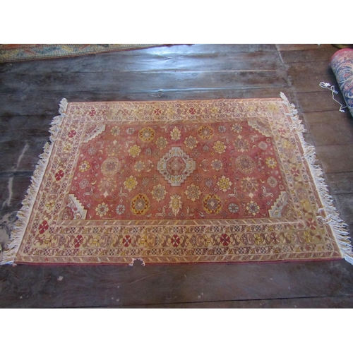 2719 - An eastern wool rug with red ground field central medallion and floral detail, within alternating re... 