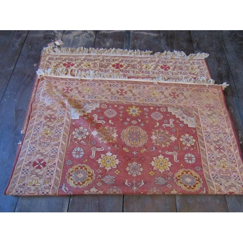 2719 - An eastern wool rug with red ground field central medallion and floral detail, within alternating re... 