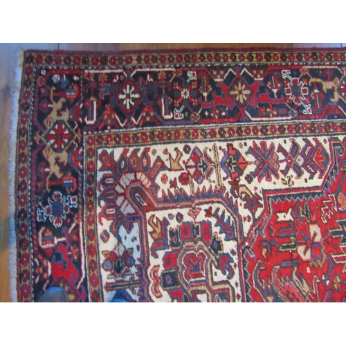 2732 - An eastern wool carpet, the central lozenge in red upon a blue and red ground field with busy abstra... 