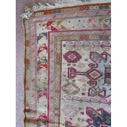 2716 - A wool rug in the eastern manner with triple medallion upon a pale cream field, within running borde... 