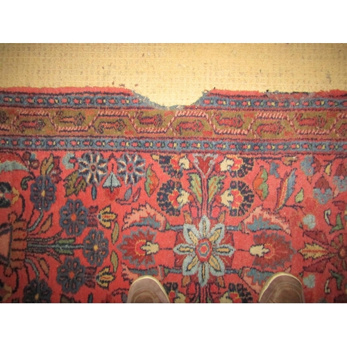 2717 - A very long eastern wool runner with repeating floral detail upon a salmon pink ground within narrow... 