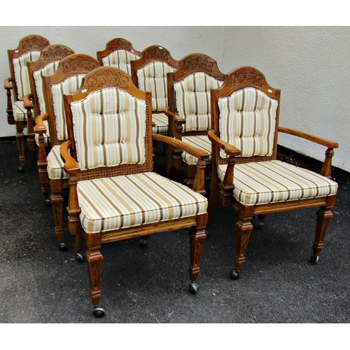 2501 - A set of eight oak open elbow chairs with moulded frames, upholstered pad seats, cane panelled and p... 