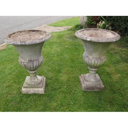 2083 - A pair of good quality weathered cast composition stone Campana shaped garden urns with flared rims ... 